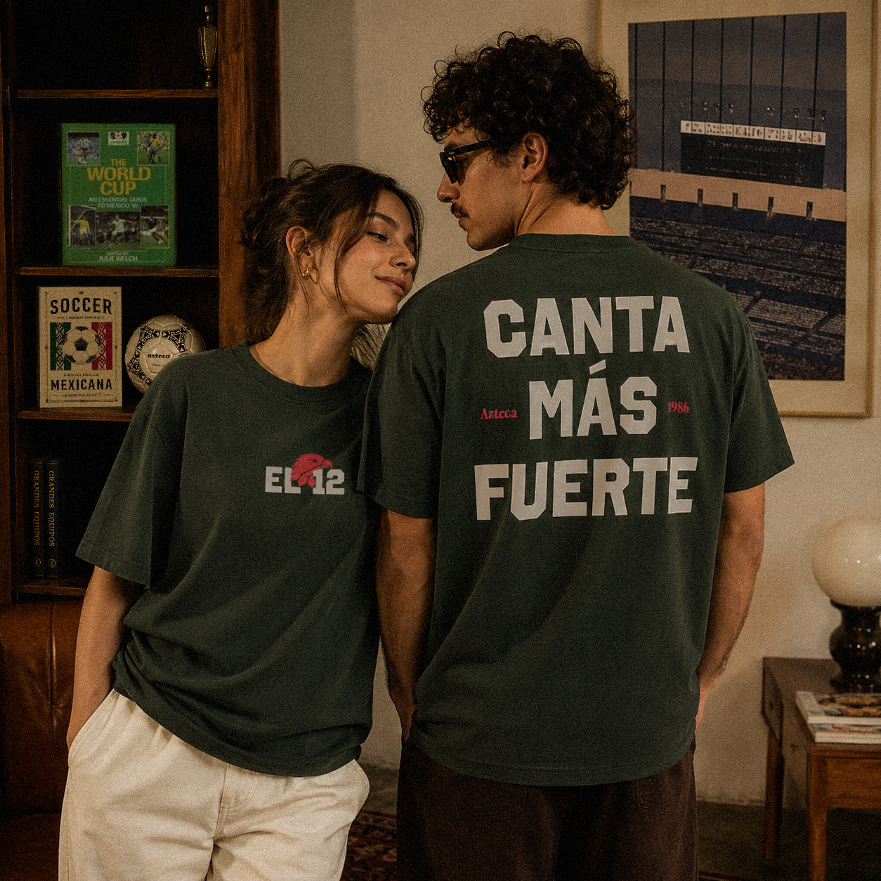 Azteca 12 tee, dark green, man wearing oversized boxy fit showing El 12 Azteca front print, outdoor lifestyle shot