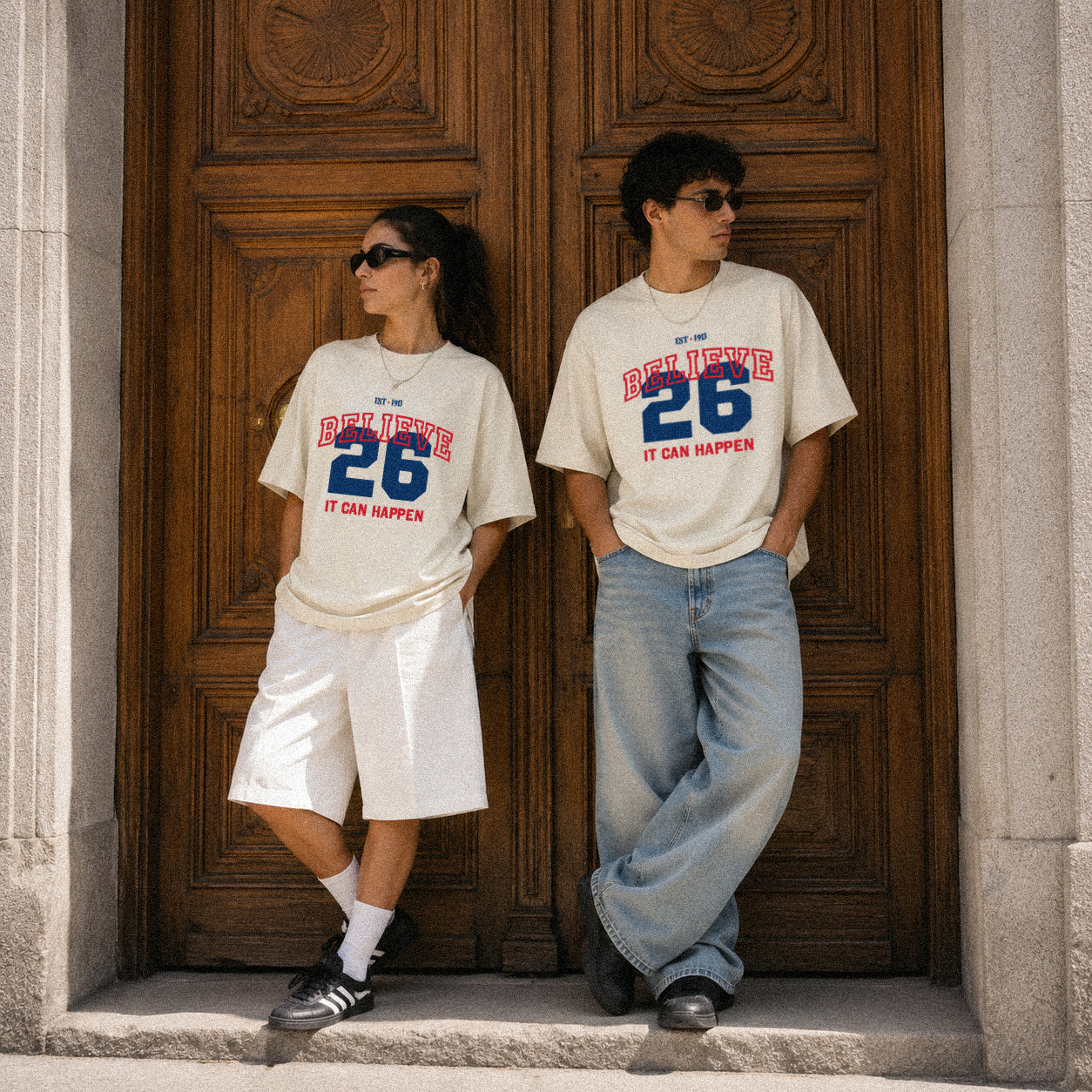 Two people wearing Setpiece by The1989 It Can Happen cream tee. USA football lifestyle.